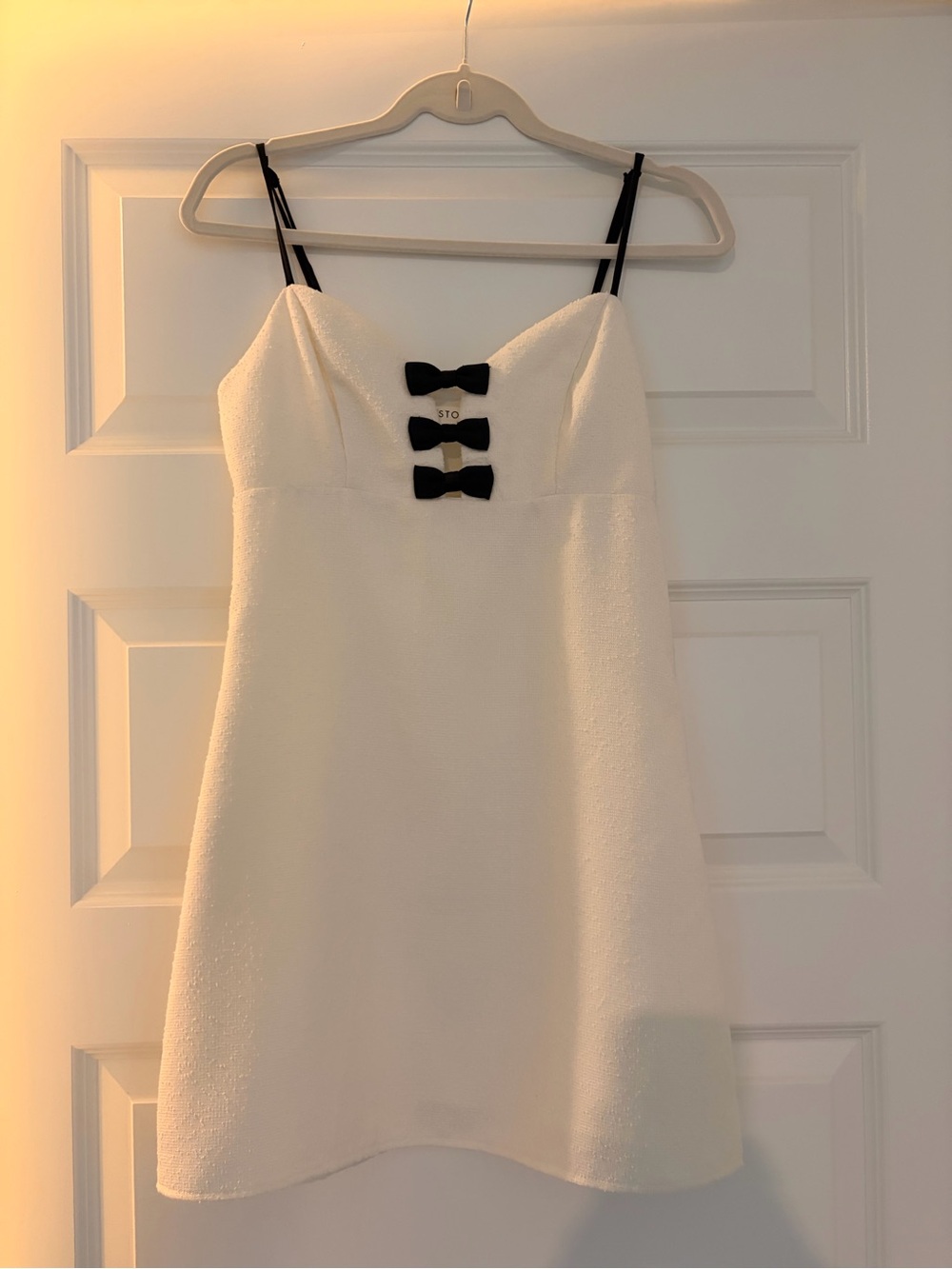Storia White Mini Dress with Black Bow Accents